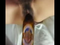 Excited boyfriend uses bottle to screw his hairy girlfriends cunt in this homemade insertion flick